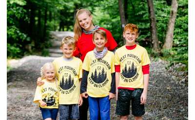 female summer camp counselor, three boys, and one girl