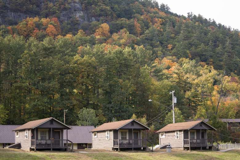 three cabins in front of a mountain