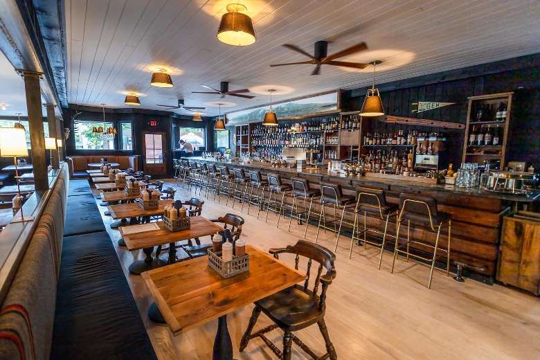 rustic tables in a restaurant dining area and a bar space