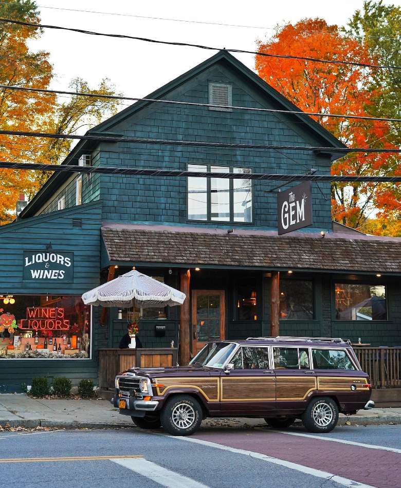 exterior of a shop and restaurant with a car in front
