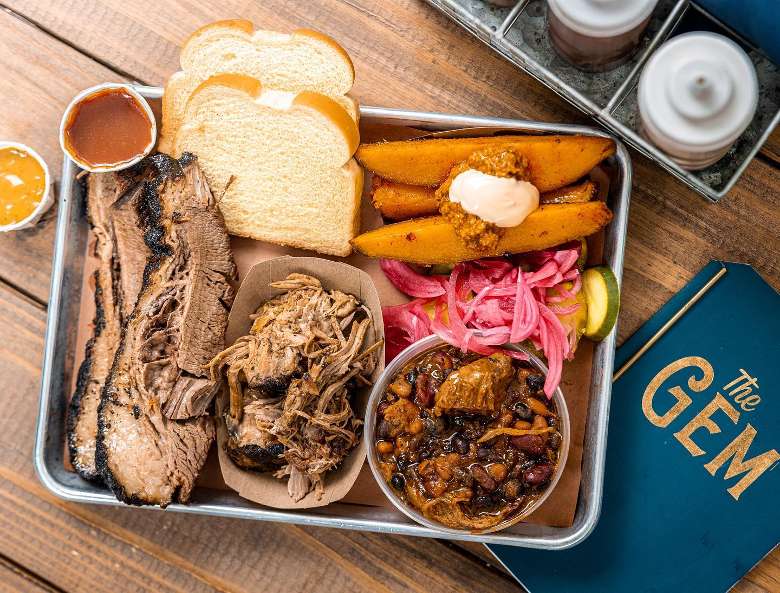 BBQ, bread, and sides on a plate