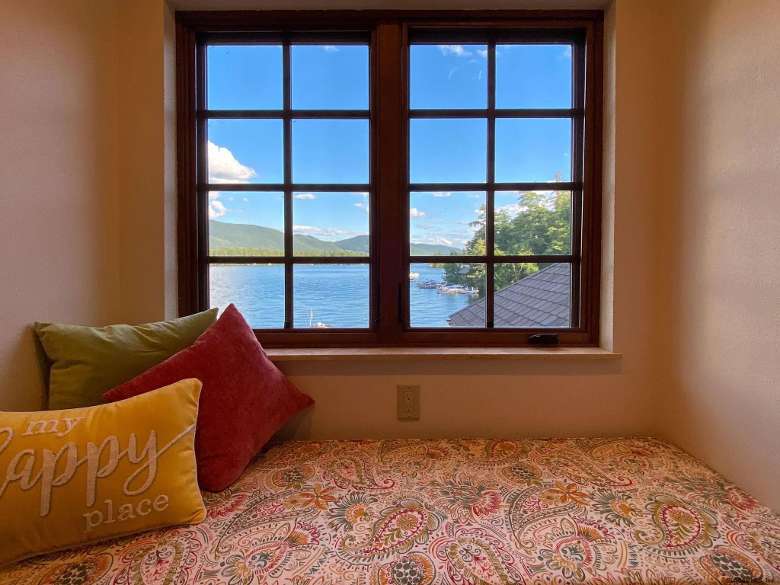 window nook with pillows, one says happy place