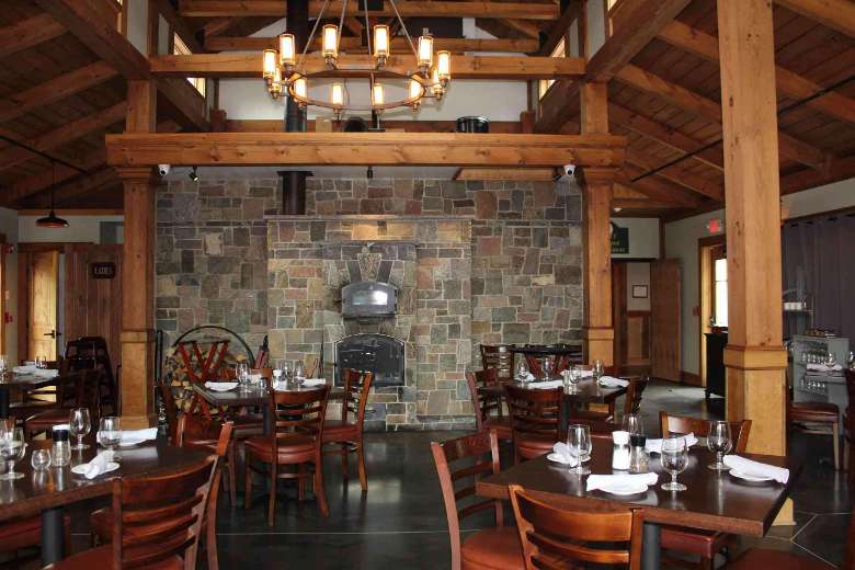 rustic dining room with a stone fireplace