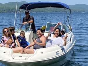 boat captain and six passengers on a lake