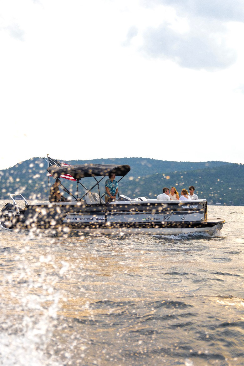 people on a lake boat with water splashing