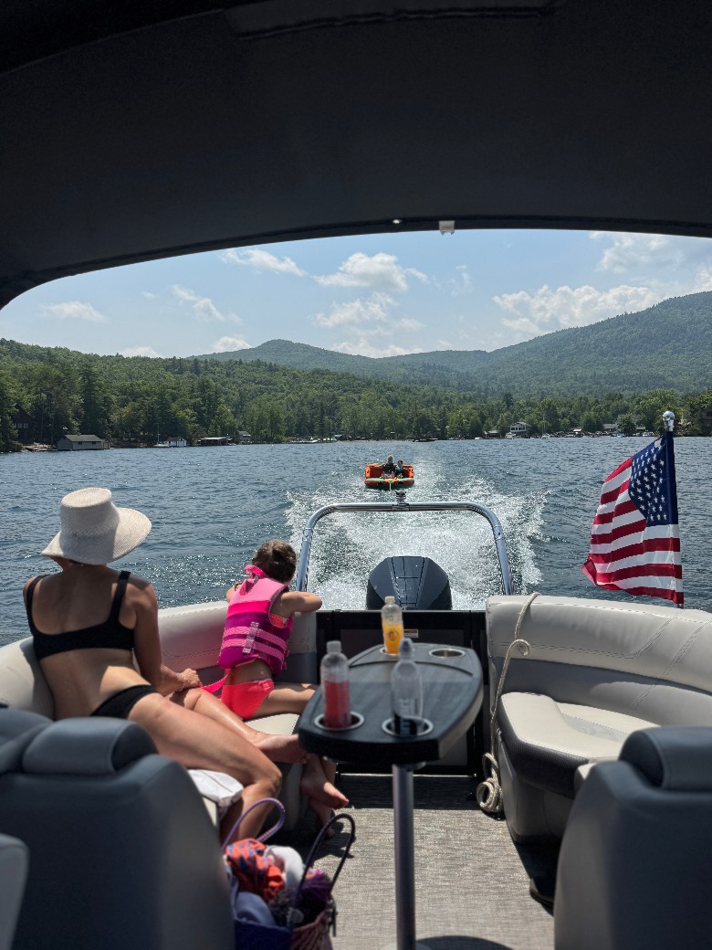 people watching others being pulled by a boat