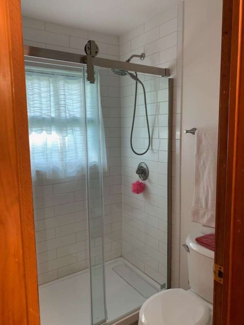 bathroom with a toilet and shower