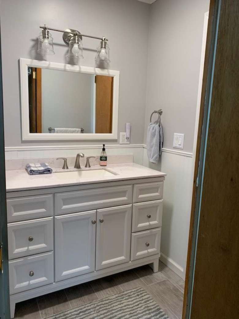 bathroom vanity with mirror over it