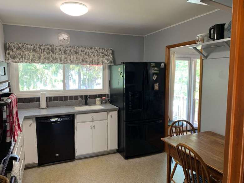a kitchen with a black fridge