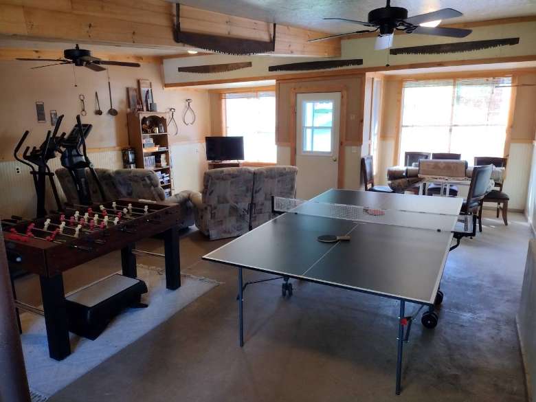 a rec room with ping pong, a meeting space, and more