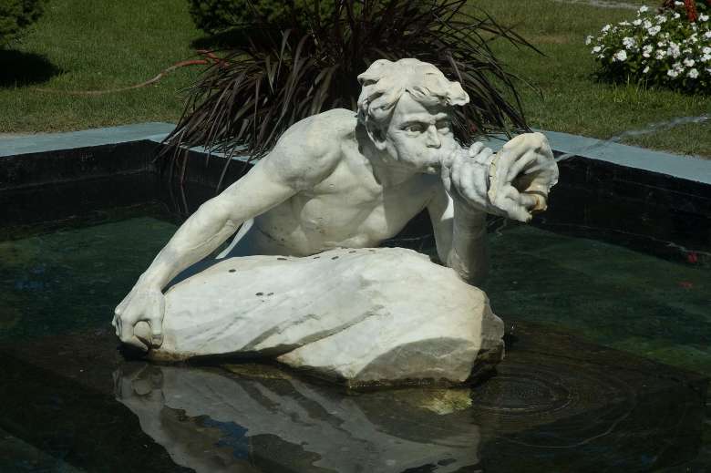statue in water with water coming out