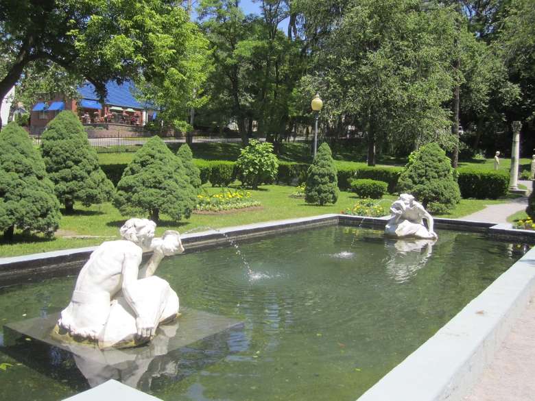 statues in a pond with water coming out