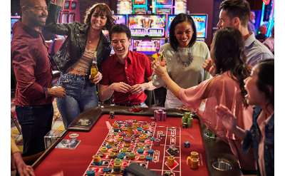 happy people around a gaming table in casino