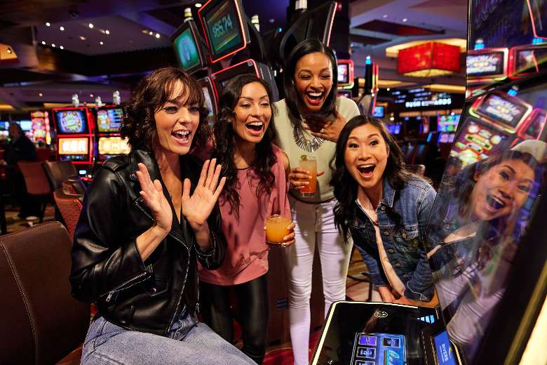 group of women squealing at slot machine