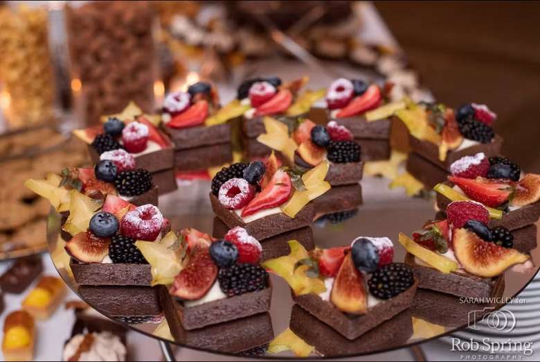 a platter of small fruit and chocolate treats