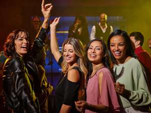 group of girls dancing to live music