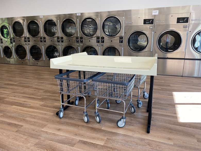 laundry table in front of washers and dryers