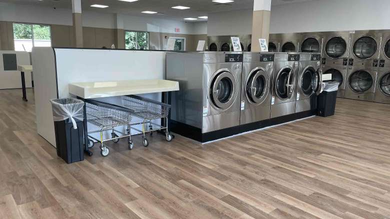 laundry table next to set of four dryers