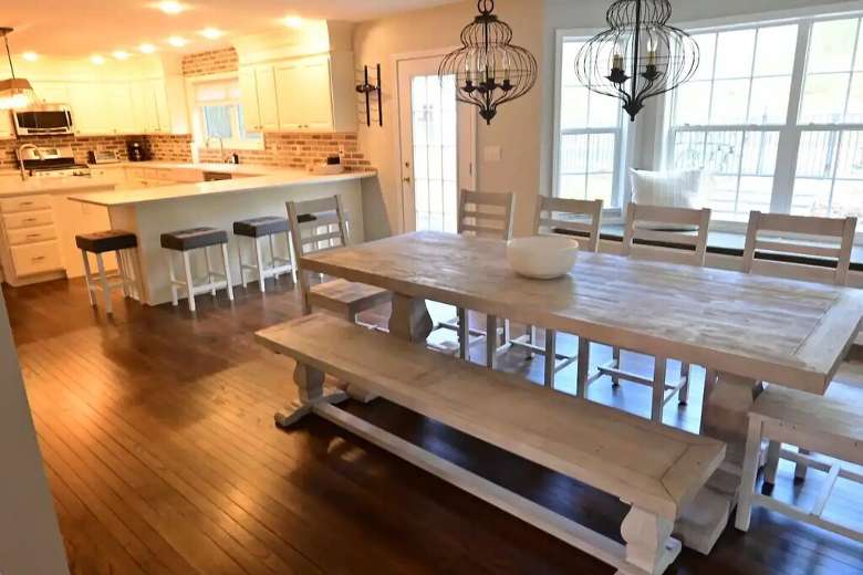 dining room table with kitchen nearby