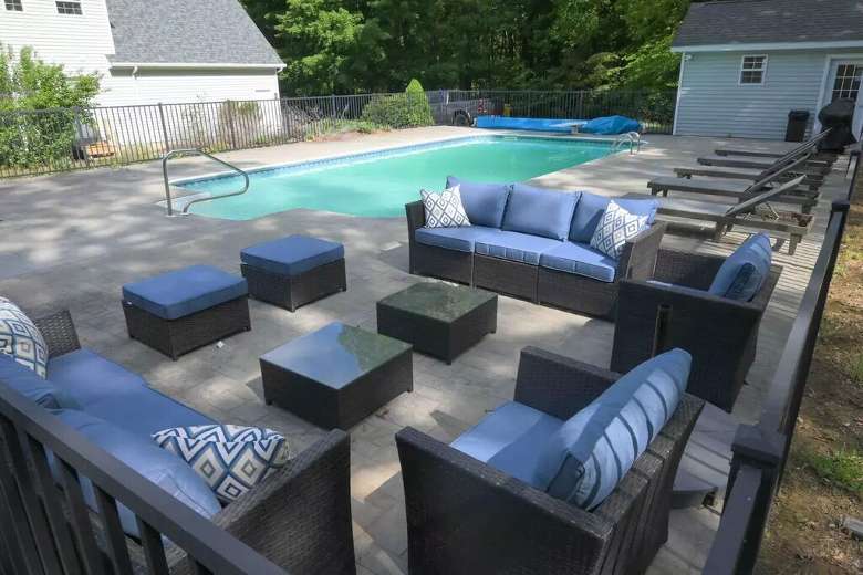 outdoor furniture by sun chairs and an outdoor pool