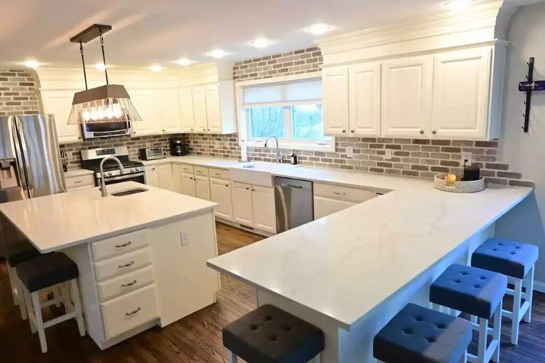 large kitchen in a house with white counters and cabinets