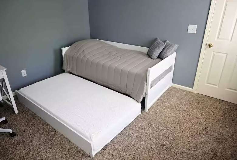 a small bed with another mattress underneath