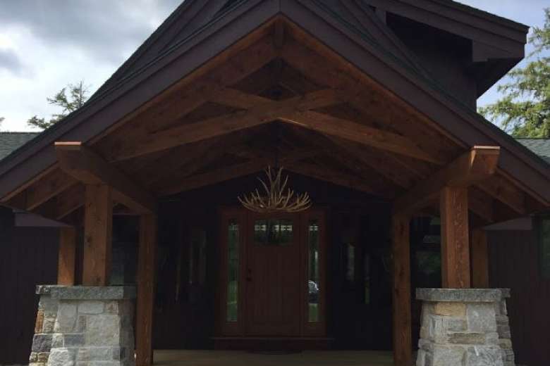 exterior of a large wooden home with covered entrance
