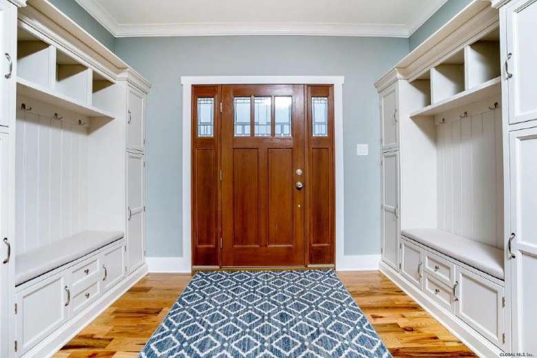 large wooden front door inside of a house