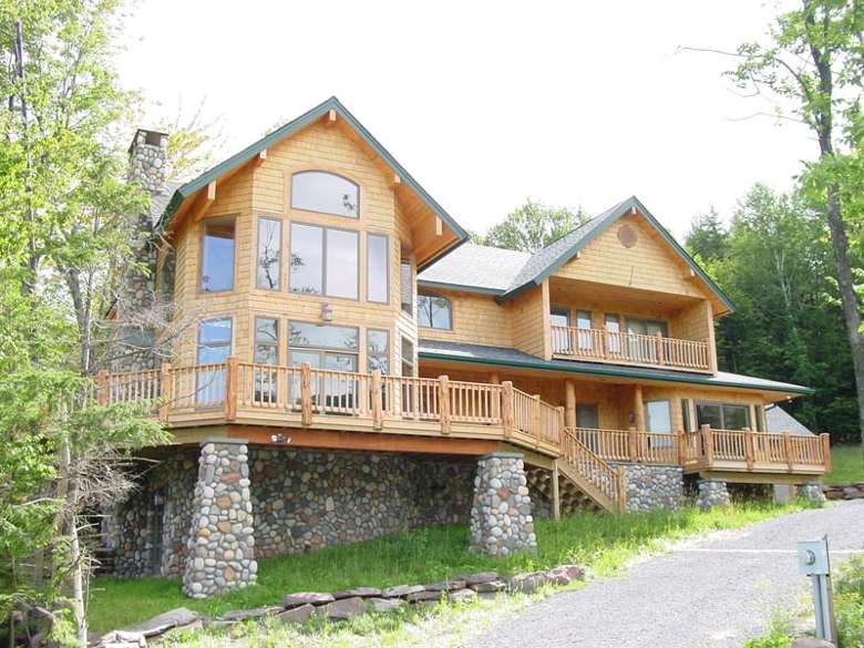 large log home with deck