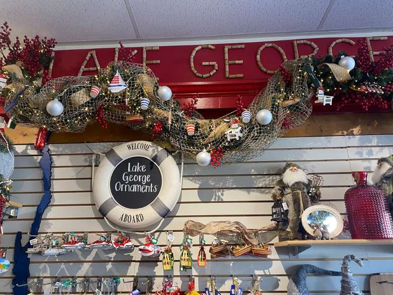 christmas and lake george items on display on store wall