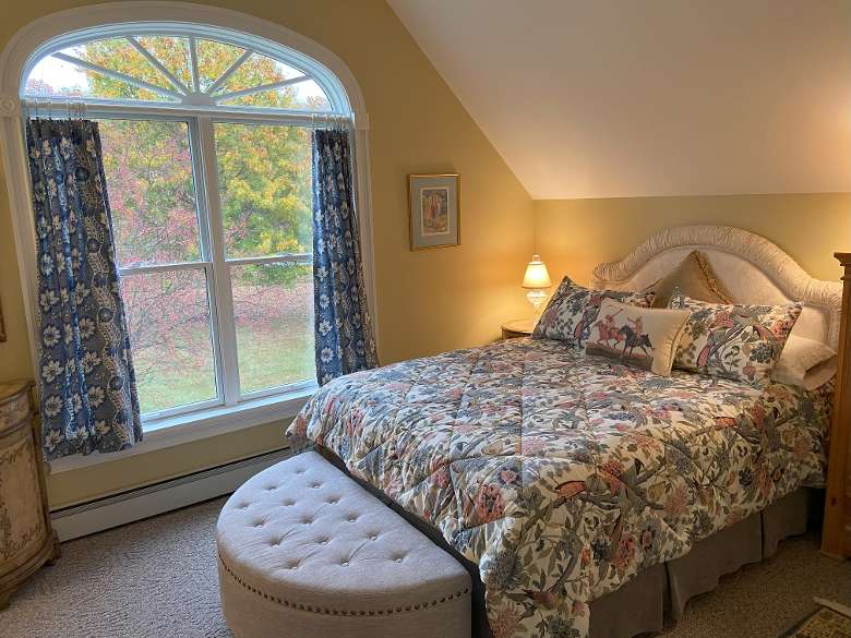 room with queen bed in it and window