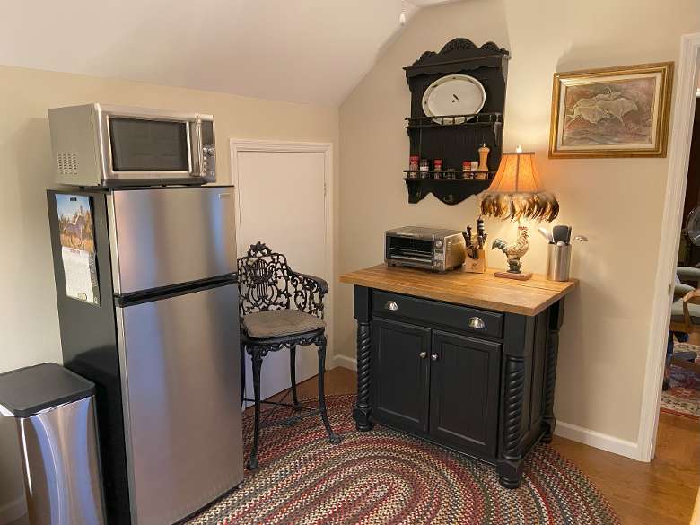 kitchen area with fridge, microwave, and small island
