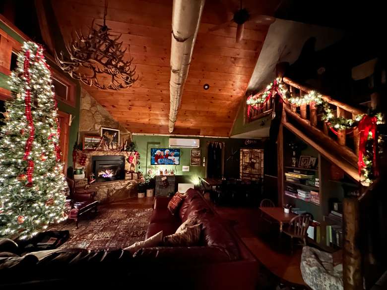interior of living room at night with lit up christmas tree