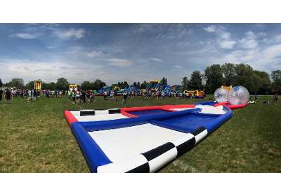 inflatable ball game set up in a grassy field