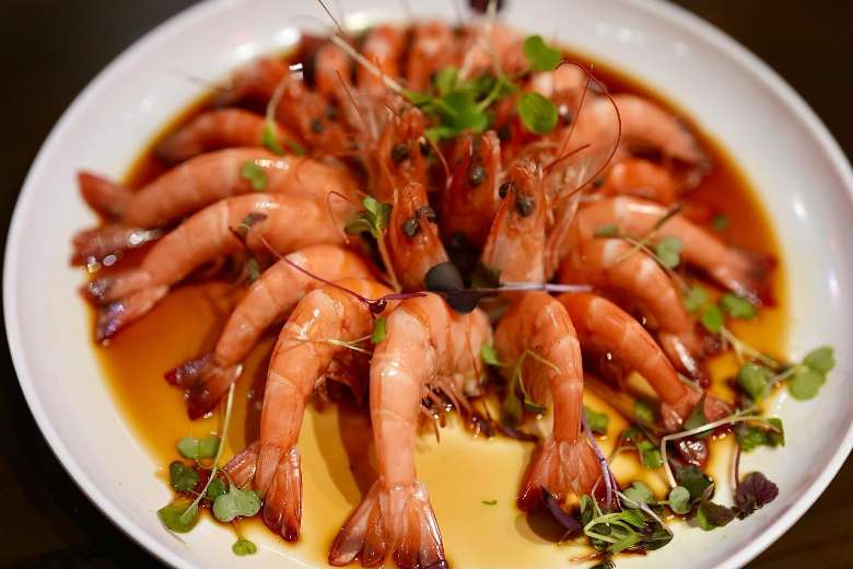 shrimp displayed on a plate in sauce