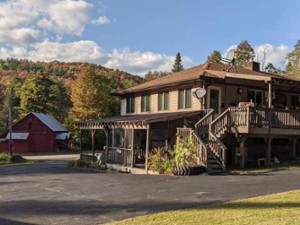 an inn with mountains in the back