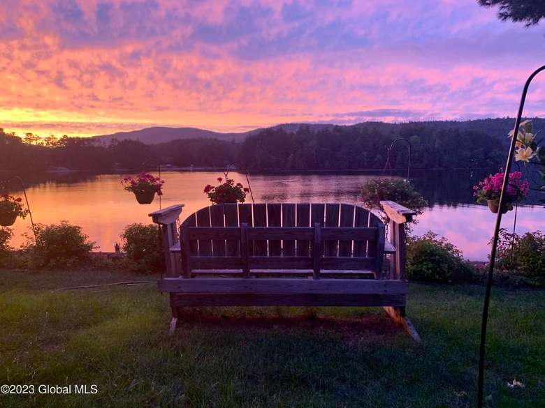 bench in front of a sunset on a lake