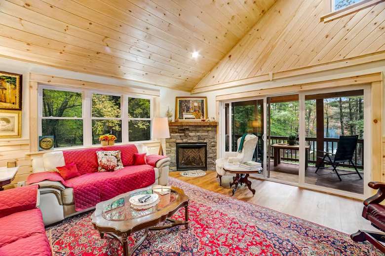 living room with vaulted ceiling and two red couches