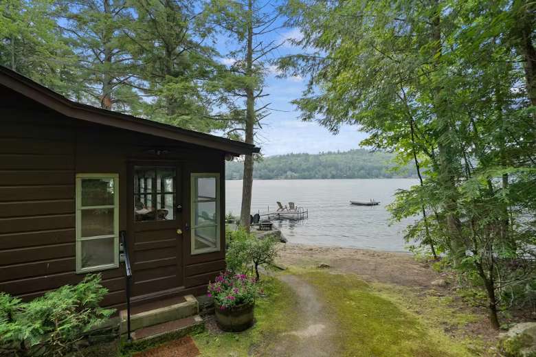 cabin situated next to a lake