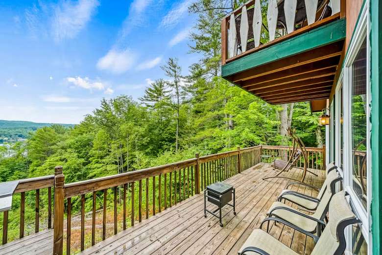 balcony with several chairs overlooking a lake