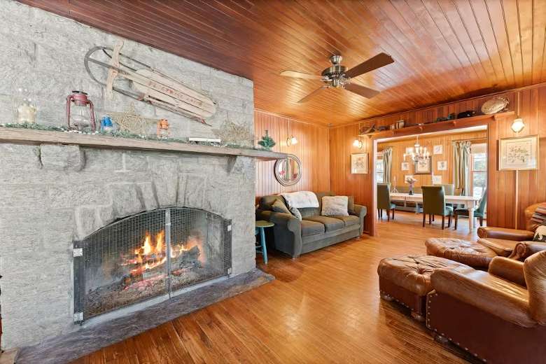 living room with stone fireplace