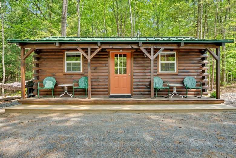 small cabin with chairs out front