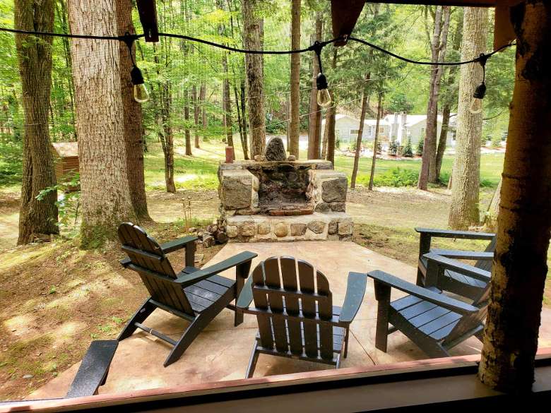 firepit with Adirondack chairs around it