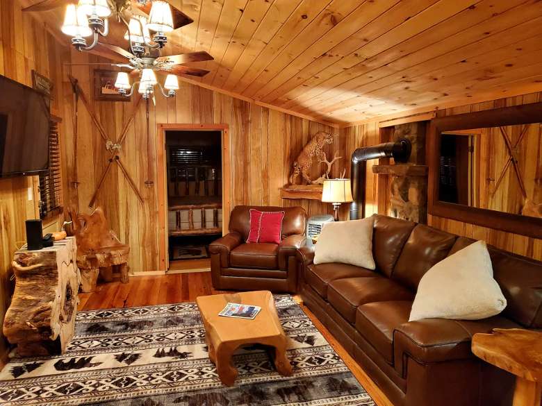 living room with leather couch and mounted television