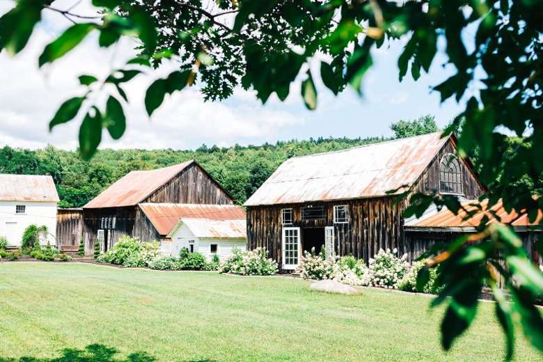 two barns with mountain background