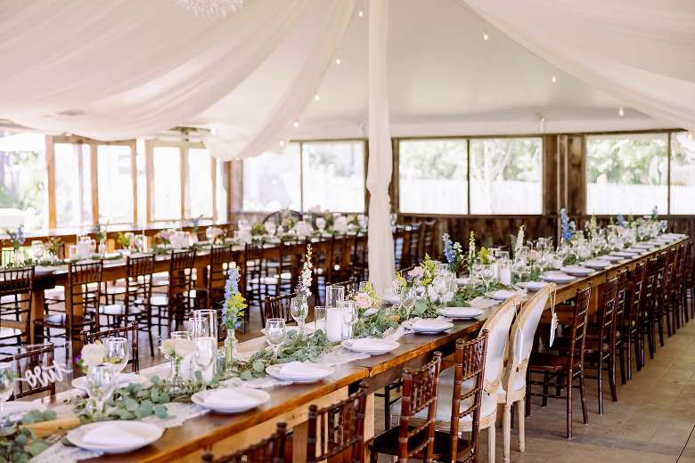 wedding tent with tables and tableware