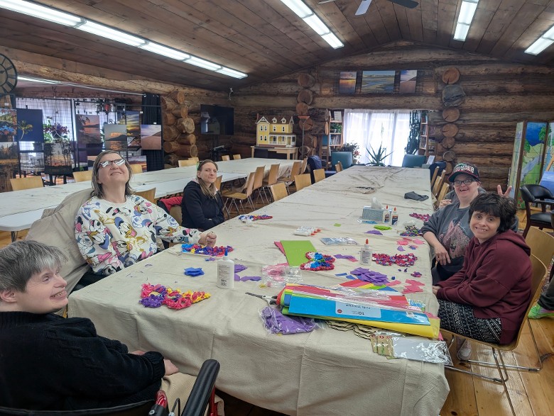 Log cabin with individuals seated at a table