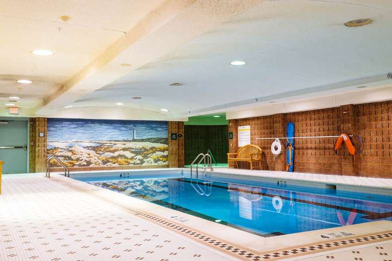 indoor pool with a mural of a beach on one wall