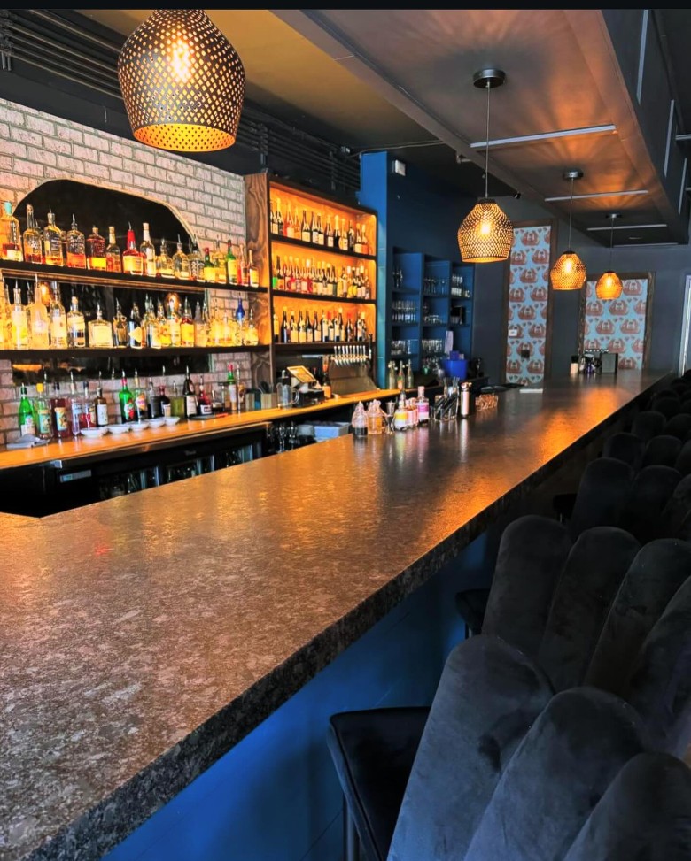 bar area with bottles behind the counter