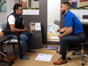 two men discussing custom orthotics